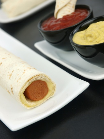  Tortilla wrap with sausage on a plateの写真素材