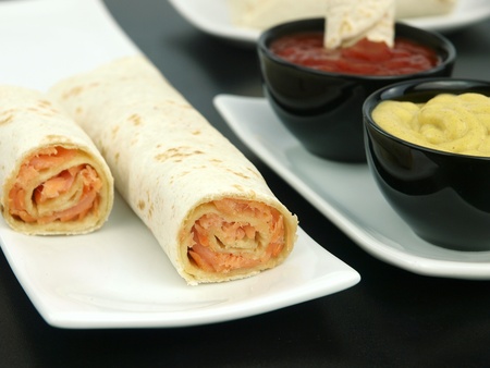 Tortilla wrap with salmon on a plateの写真素材