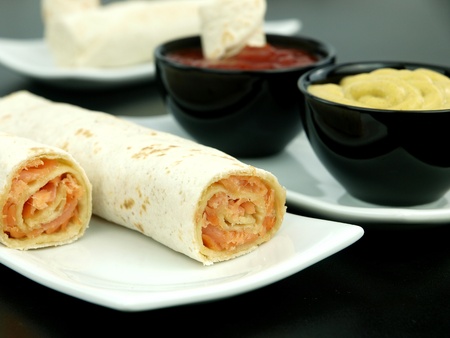 Tortilla wrap with salmon on a plateの写真素材