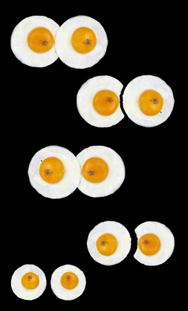 Fried eggs like eyes in a black panの写真素材