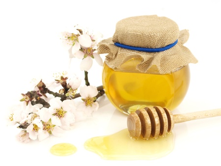  Honey in a jar, flowers and honey dipper on white backgroundの写真素材