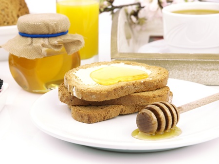 Honey on toast, with a breakfast set backgroundの写真素材