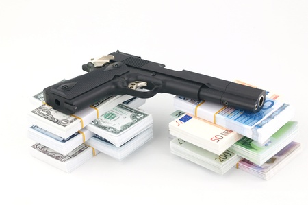 Gun and money on the white backgroundの写真素材