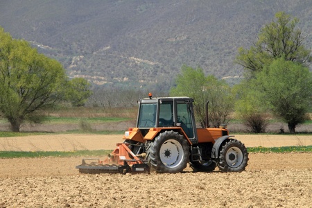 A tractor ploughing a fieldの写真素材