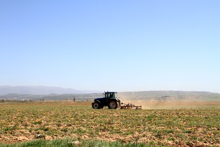 A tractor ploughing a fieldの写真素材