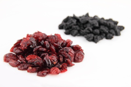 Dried blueberries and cranberries isolated on white backgroundの写真素材