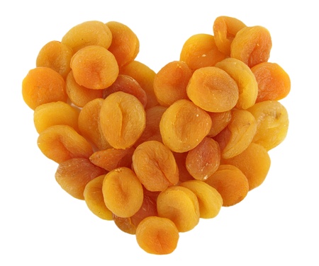 Heart of dried apricots isolated on white backgroundの写真素材