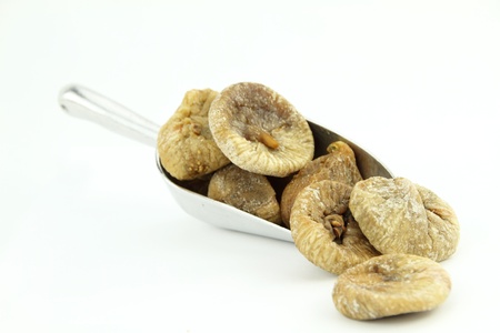 Dried figs in scoop isolated on white backgroundの写真素材
