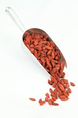 Goji berries in scoop isolated on white backgroundの写真素材
