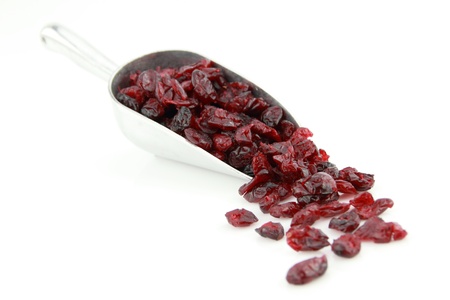 Dried cranberries in scoop over white backgroundの写真素材