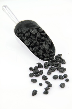 Dried Blueberries in scoop over white backgroundの写真素材