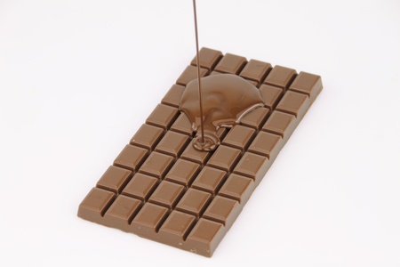 Melted chocolate dripping on white backgroundの写真素材