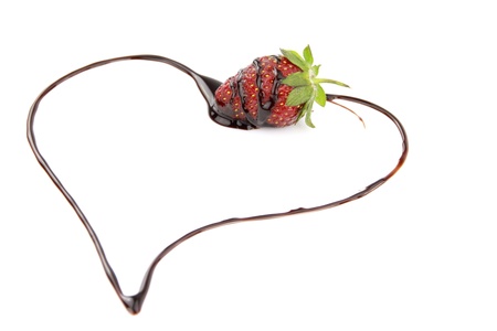 Heart shape from chocolate sauce covered strawberryの写真素材