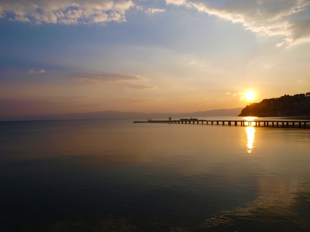 Romantic couple walk on the jetty at sunset   の写真素材