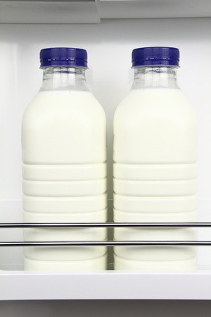 Bottles of fresh milk in the fridgeの写真素材