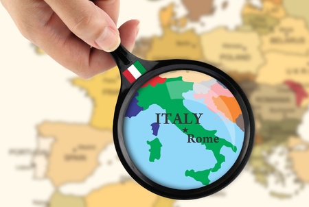 Magnifying glass over a map of Italyの写真素材
