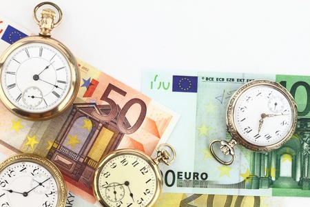 Antique pocket clocks and moneyの写真素材