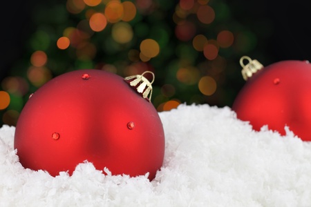 Red Christmas balls on snow の写真素材