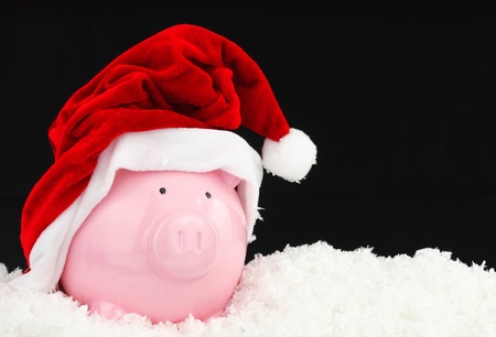 Santa Claus piggy bank on snowの写真素材