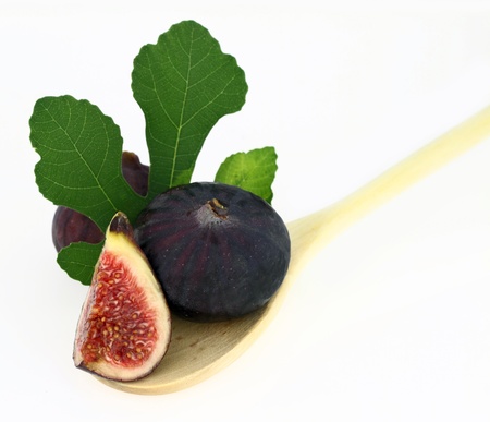 Fresh figs in a wooden spoonの写真素材