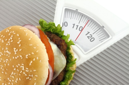 Burger on a weight scaleの写真素材