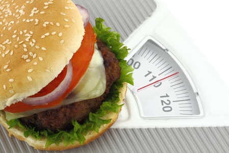 Burger on a weight scaleの写真素材