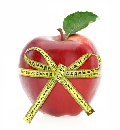 Diet concept. Apple with measuring tapeの写真素材
