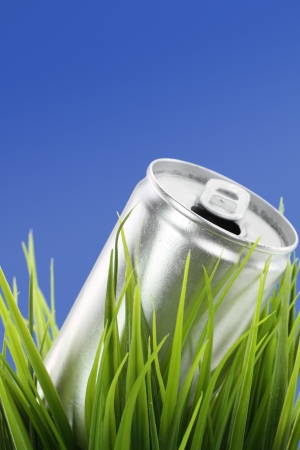 Recycle concept. Drink can on green grassの写真素材