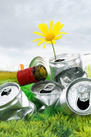 Garbage with growing daisy under storm cloudsの写真素材