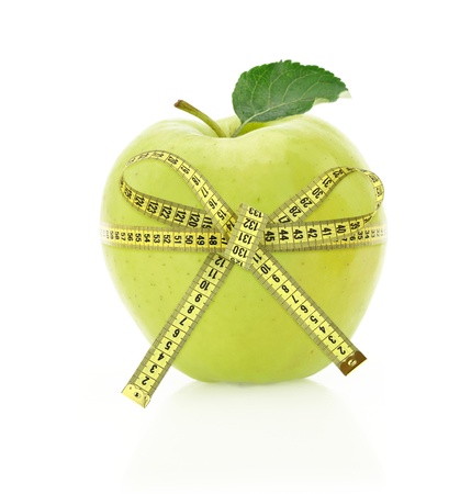 Diet concept. Apple with measuring tapeの写真素材