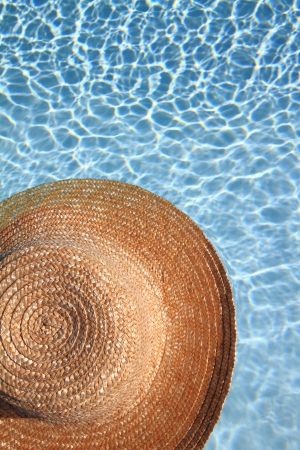 Straw hat in the poolの写真素材