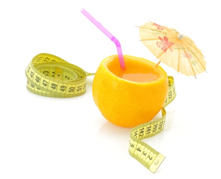 Diet concept. Orange juice with measure tapeの写真素材