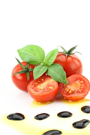 Tomato and basil garnished with olive oil and balsamic vinegarの写真素材