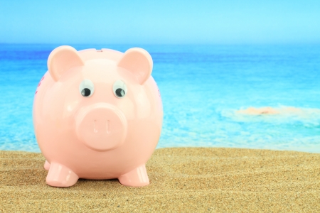 Summer piggy bank on the beach の写真素材