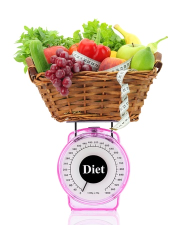 Diet concept. Kitchen scale with fruits and vegetablesの写真素材