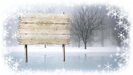 Wooden sign on snowy field の写真素材