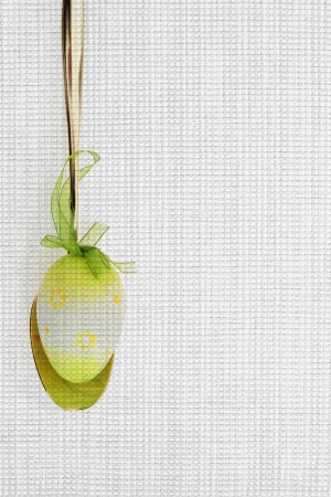 Golden spoon and Easter egg on fabric texture for your recipeの写真素材