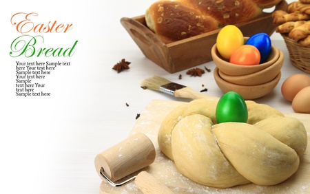 Easter sweet bread dough with multicolored eggs 