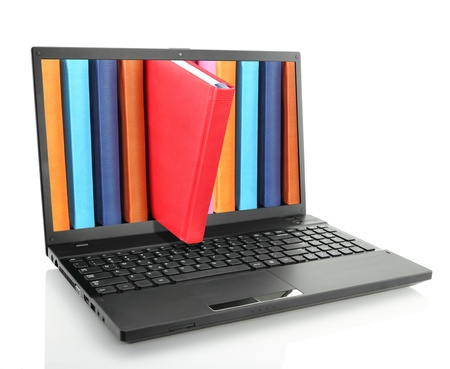 Laptop computer with colored books の写真素材