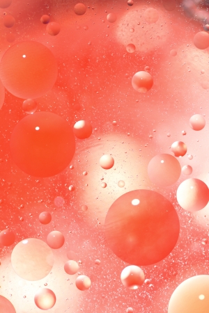 Abstract red background with bubbles in the waterの写真素材