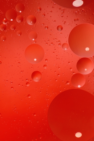Abstract red background with bubbles in the waterの写真素材
