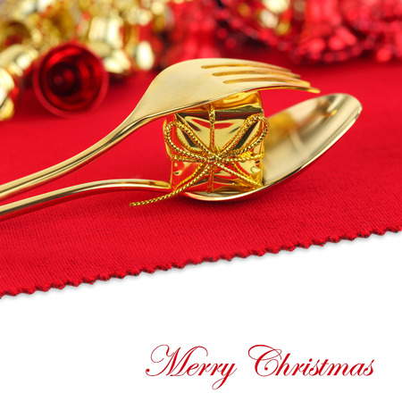 Christmas golden cutlery with ornament on red backgroundの写真素材