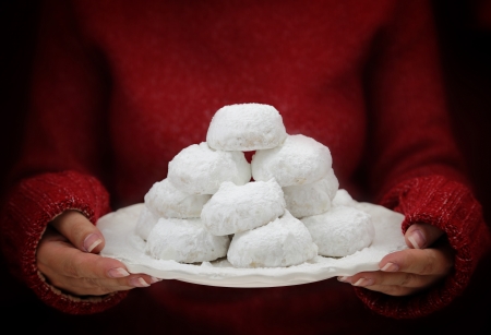Female hands holding traditional Greek butter cookies Kourabiedesの写真素材