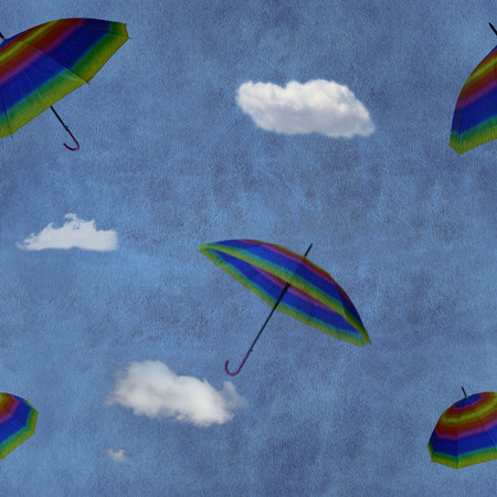 Flying colorful umbrellas on blue sky seamless patternの写真素材