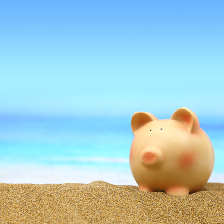 Summer piggy bank on the beachの写真素材