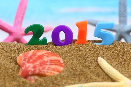Multicolored new year 2015 on the beach