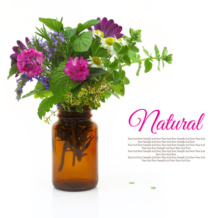 Fresh herbs and flowers in a medical bottleの写真素材