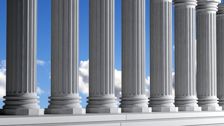 Ancient marble pillars in a row with blue skyの写真素材