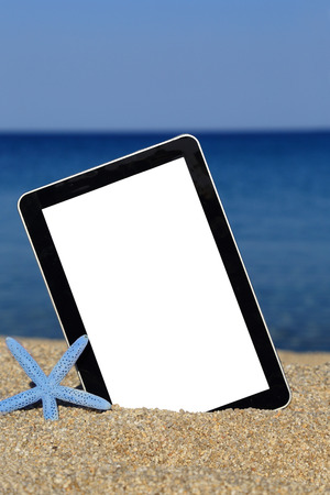 Promotional tablet template on the beach の写真素材