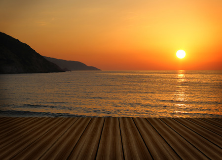 Wooden deck with sunset seascape の写真素材